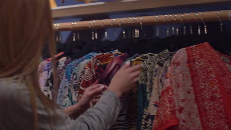 Dos-amigos-observando-un-camisetas-con-patrones-en-una-tienda-bien