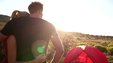 Camping-Hiker-drinking-coffee-in-nature-next-to-tent