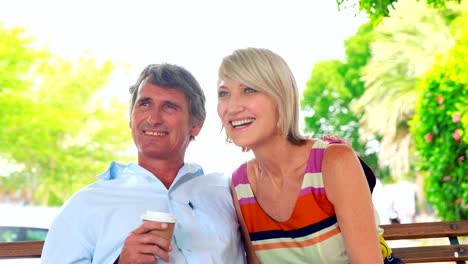 Smiling-couple-sitting-on-a-bench