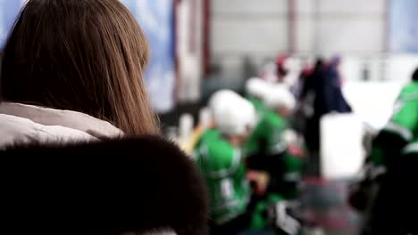 Female-fan-waiting-for-favorite-hockey-player-to-take-autograph-after-match