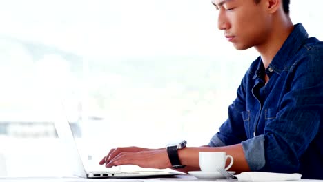 Man-using-laptop-with-coffee