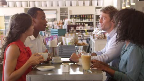 Group-Of-Friends-Enjoying-Drink-In-Cafe-Shot-On-R3D