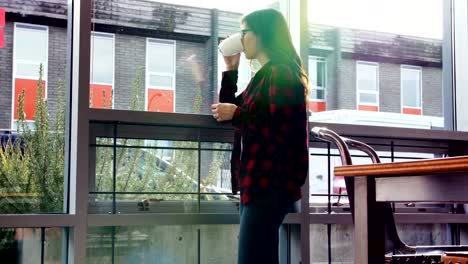 Thoughtful-female-executive-drinking-coffee