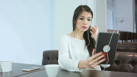 Pretty-young-woman-checking-her-make-up-using-tablet-and-preparing-for-video-call