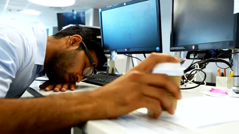 Male-executive-sleeping-at-desk