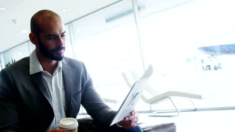 Businessman-having-coffee-while-reading-a-document