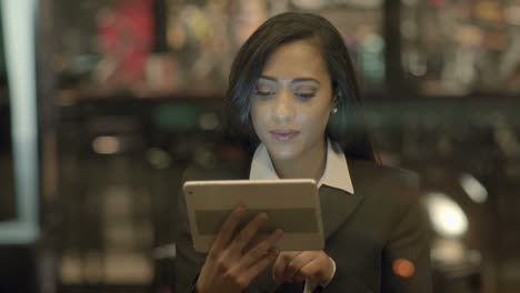 Young-Attractive-Black-Women-Using-Tablet-Computer-Searching-the-Web-Online.-African-American-Female-in-Business-Suit-Connecting-with-Social-Media.-Urban-Lifestyle-Background