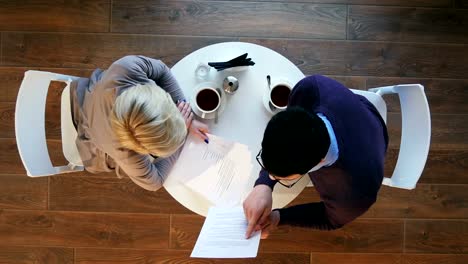 Two-business-people-during-work-meeting-in-modern-cafe