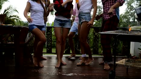 Young-People-Dancing-While-Cooking-Barbecue-Frineds-Group-Gathering-On-Summer-Terrace-Having-Party-Legs-Closeup-View