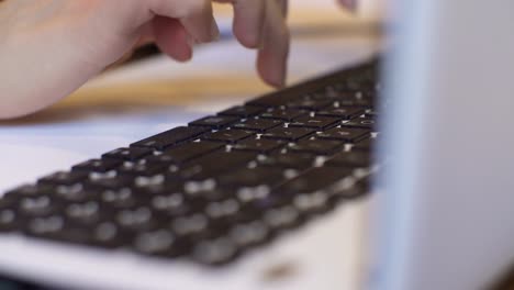 Young-attractive-businesswoman-working-on-modern-laptop-in-cafe