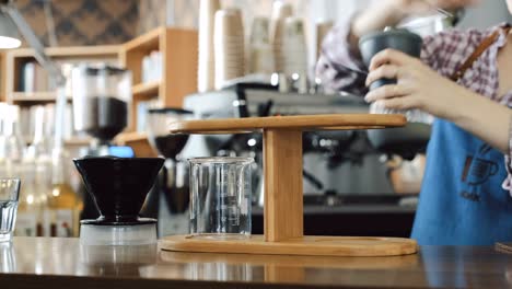 Barista-grinding-coffee-beans