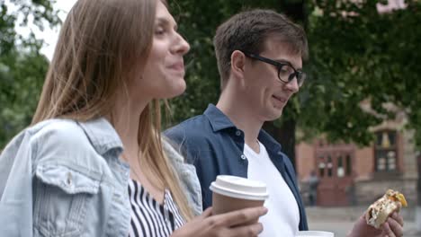 Boyfriend-and-Girlfriend-Walking-with-Coffee-and-Sandwich