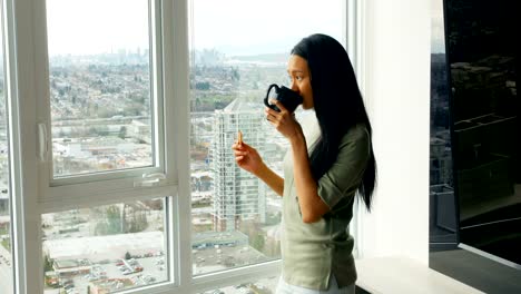 Woman-having-coffee-at-home-4k