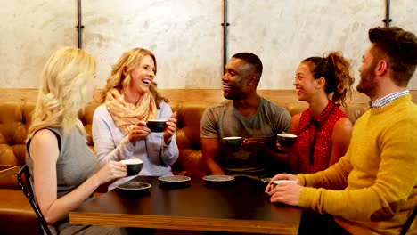 Group-of-happy-friends-interacting-while-having-coffee-4K-4k