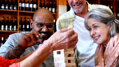 Happy-friends-playing-jenga-game-while-having-coffee-4k