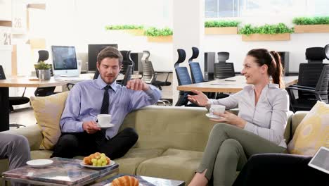 Grupo-de-ejecutivos-interactuando-al-mismo-tiempo-que-café-4k