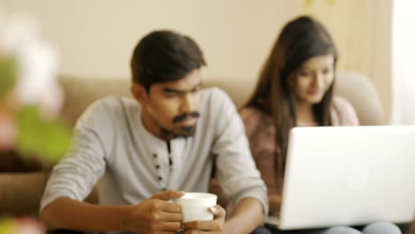 Happy-young-friends-using-laptop