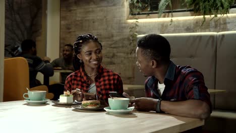 Young-Black-couple-eating-refreshments-at-a-cafe