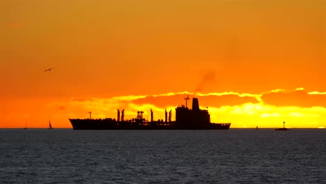 Cargo-container-ship-sailing-on-the-sea-at-sunset-in-4k-slow-motion