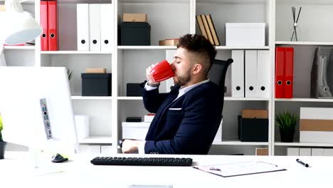 young-businessman-drinking-coffee-at-workplace