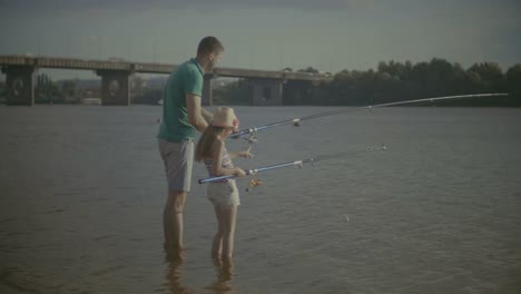 Father-and-daughter-enjoying-fishing-together