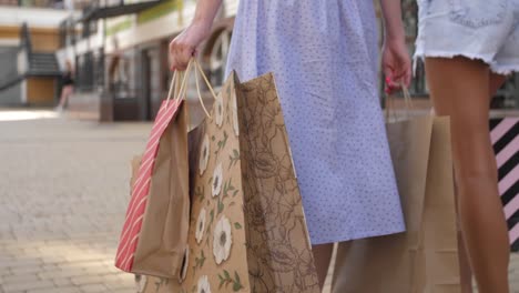 Back-view.-Low-shot-of-female-legs-walking-on-street-in-colorful-garments.-4K-slow-motion