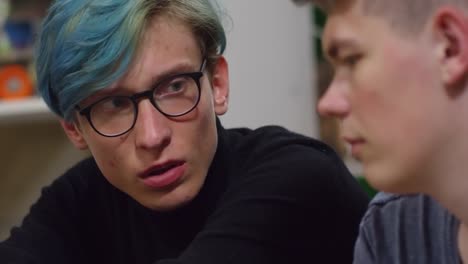 Young-Man-in-Glasses-Talking-to-Friend