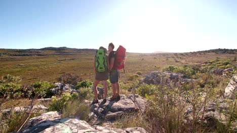 Fit-woman-hiking-with-trekking-friend-outdoors-in-summer-nature