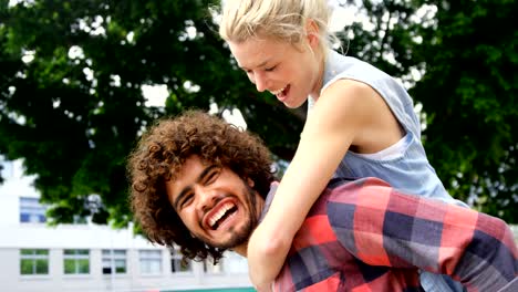 Young-men-giving-piggyback-ride-to-woman