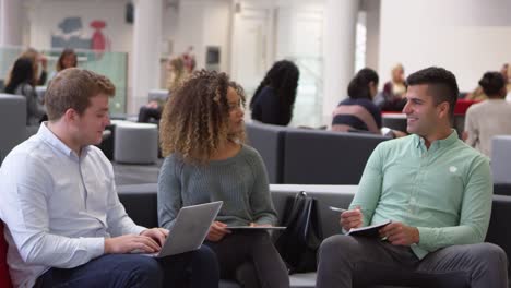 Students-studying-together-in-a-modern-university-lobby,-pan,-shot-on-R3D