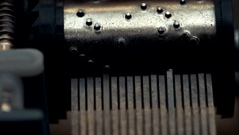 Detailed-view-of-the-insides-of-an-old-vintage-music-box-as-it-plays.-Slow-tracking-movements