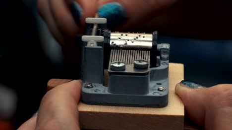 Detailed-view-of-the-insides-of-an-old-vintage-music-box-as-it-plays.-Slow-tracking-movements