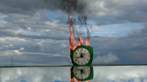 Burning--old-retro-green-alarm-clock-on-mirror-in-space