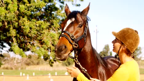 Woman-standing-with-the-horse-in-the-ranch-4k