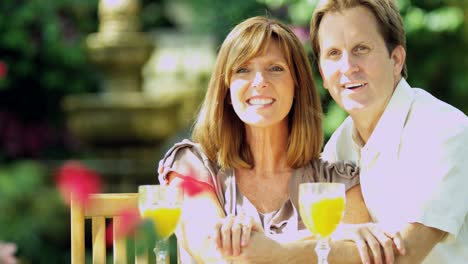 Young-couple-relaxing-in-garden-enjoying-leisure-time