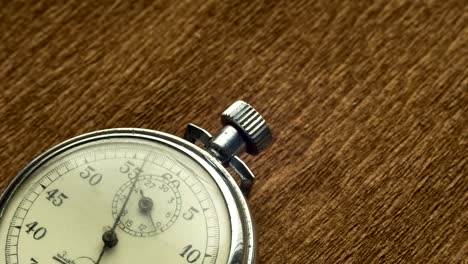 Vintage-Dial-White-Stopwatch-on-the-Brown-Structural-Background-Rotates-the-Arrow