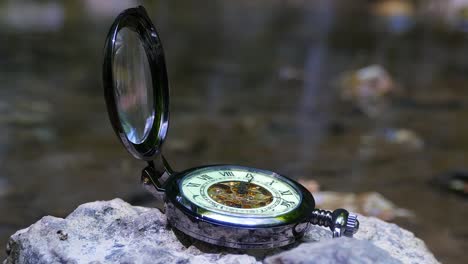 Reloj-de-bolsillo-con-río-en-fondo