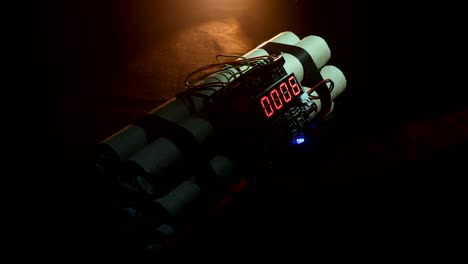 Time-bomb-against-dark-background.-Timer-counting-down-to-detonation-illuminated-in-a-shaft-light-shining-through-the-darkness.-Conceptual-footage