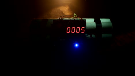 Time-bomb-against-dark-background.-Timer-counting-down-to-detonation-illuminated-in-a-shaft-light-shining-through-the-darkness.-Conceptual-footage