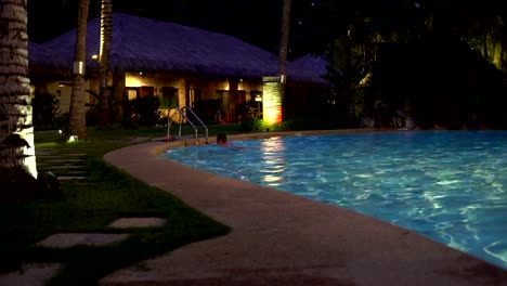 In-the-outdoor-pool-man-swims-up-to-the-stairs-and-goes