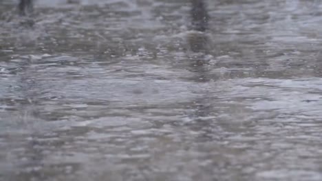 Drops-of-Rain-Fall-to-the-Pavement-Forming-a-Puddle.-Time-Lapse