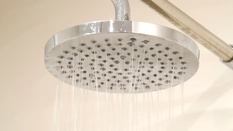 Shower-head-in-bathroom-with-water-drops-falling-in-4k-slow-motion-60fps