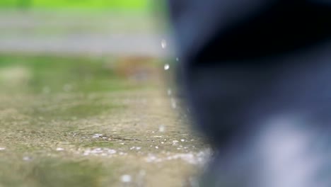 Man-in-black-shoes-stepping-into-the-puddle-in-4k-slow-motion-60fps