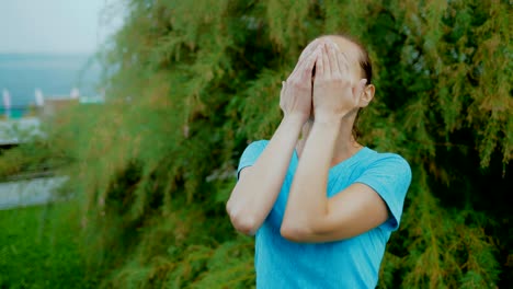 Portrait-of-happy-wiping-raindrops-from-her-face