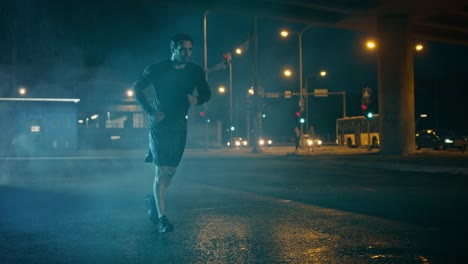 Athletic-Muscular-Young-Man-in-Sports-Outfit-is-Jogging-in-the-Street-on-a-Rainy-Evening.-He-is-Running-in-an-Urban-Environment-Under-a-Brindge.