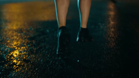 Close-Up-Leg-Shot-of-an-Athletic-Young-Man-in-Sports-Outfit-Jogging-in-a-Rainy-Street.-He-is-Running-in-a-Dark-Urban-Environment-Under-a-Brindge-with-Cars-in-the-Background.