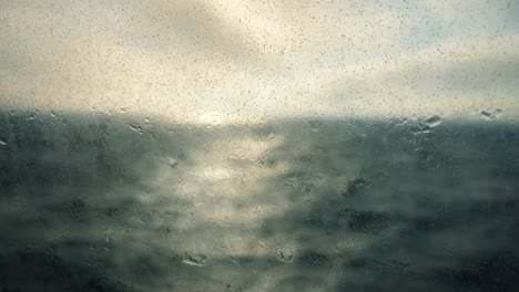 Grunge-shot-of-a-slow-motion-ship-window-with-spray-and-sand.