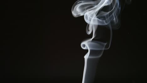 SLOW-MOTION:-Curly-steam-of-smoke-on-a-black-background