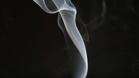 SLOW-MOTION:-Smoke-steam-into-cigarette-smoke-on-a-black-background