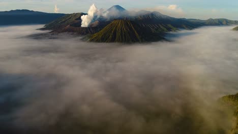 Aerial-view-flight-over-Cemoro-Lawang,-small-village-in-morning-mist.